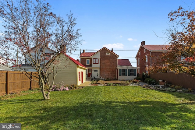 back of house with a lawn