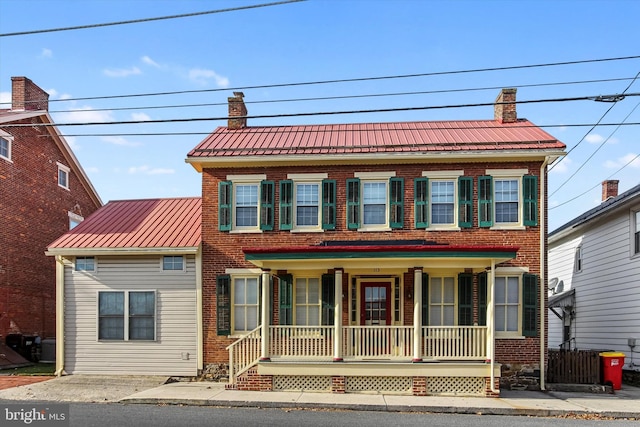 colonial house featuring covered porch