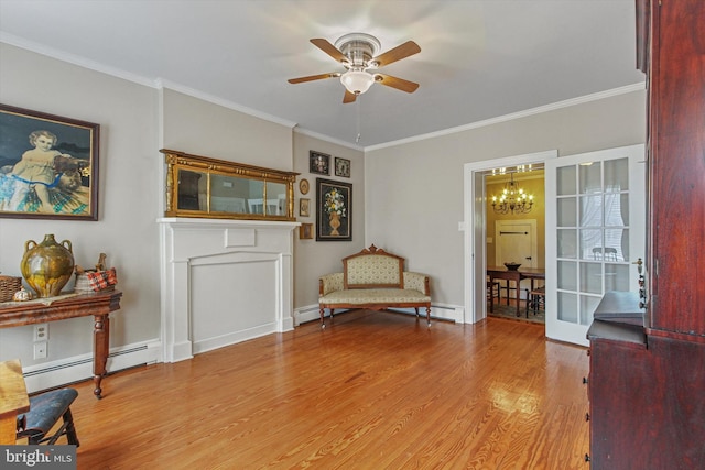 sitting room with a baseboard radiator, ceiling fan with notable chandelier, ornamental molding, and light wood-type flooring