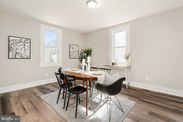 dining room with dark hardwood / wood-style flooring