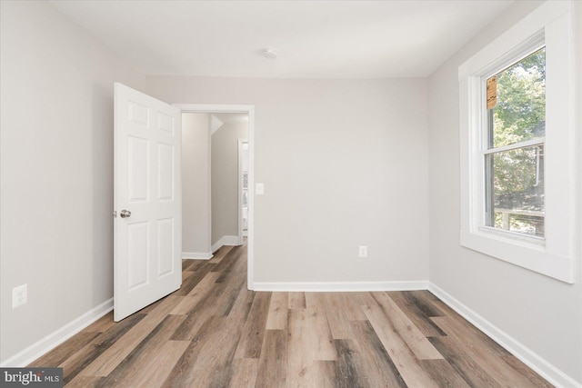 empty room with wood-type flooring