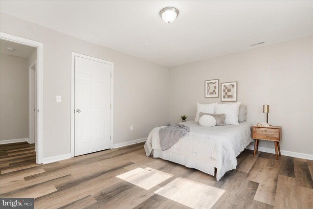 bedroom with hardwood / wood-style flooring