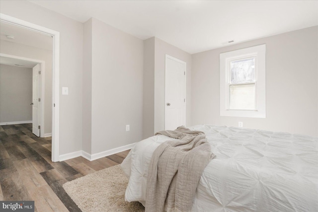 bedroom featuring dark wood-type flooring