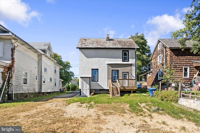 back of house with a wooden deck