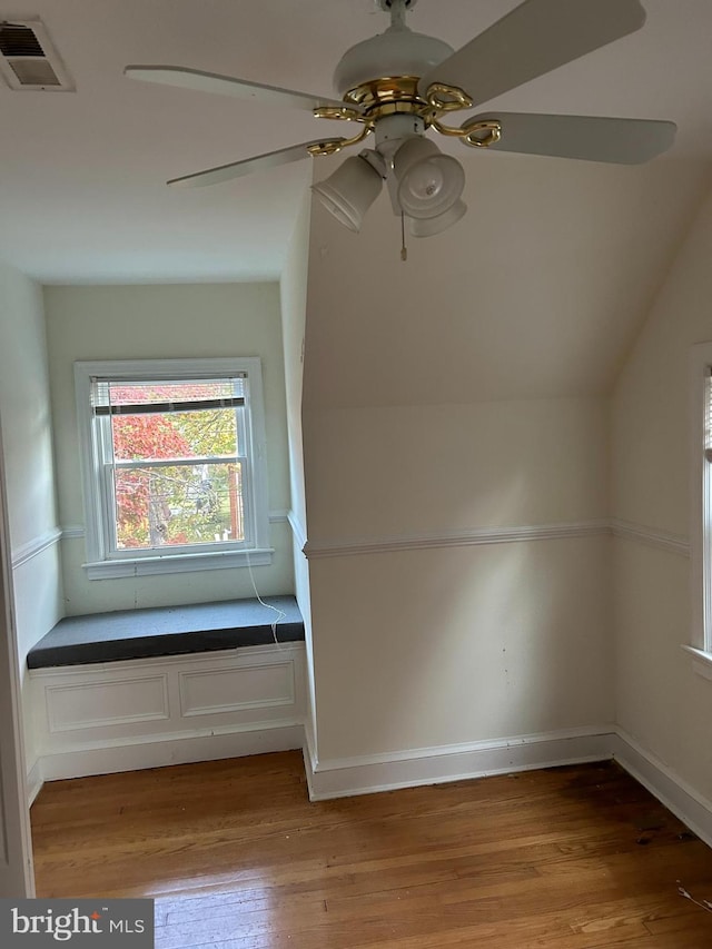 additional living space with visible vents, light wood-style floors, and ceiling fan