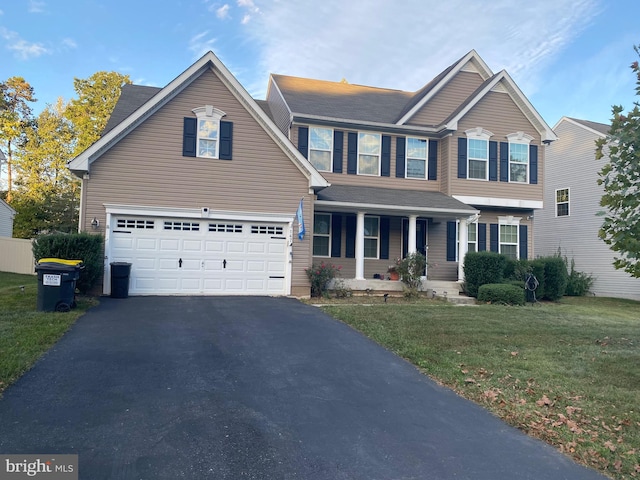 view of front of home featuring a front yard and a garage