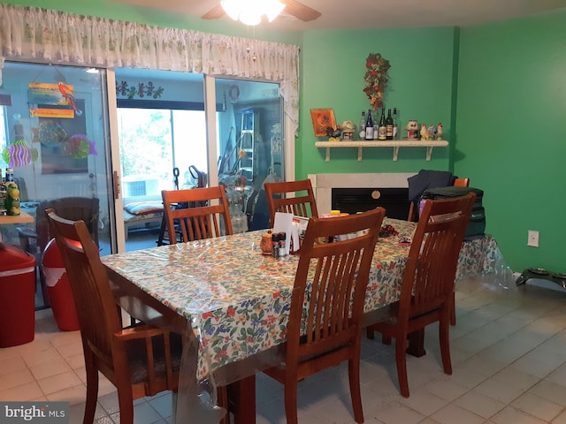 tiled dining space with ceiling fan