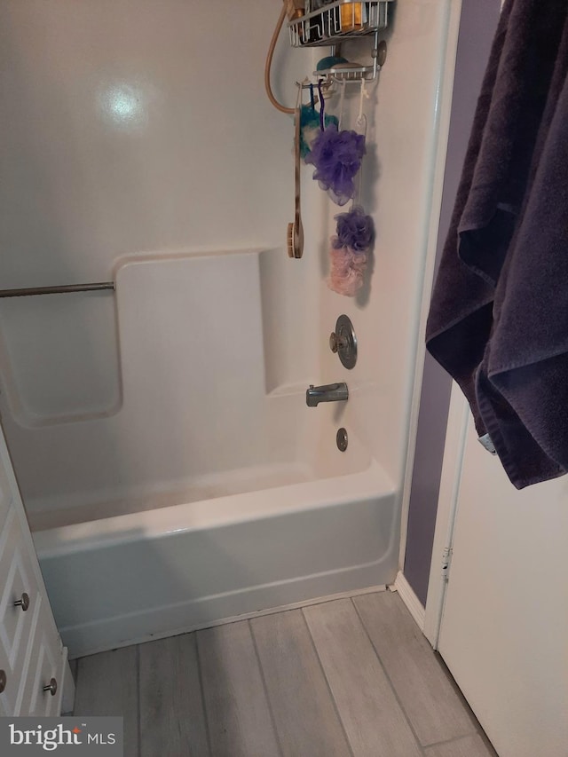 bathroom featuring shower / washtub combination and hardwood / wood-style flooring