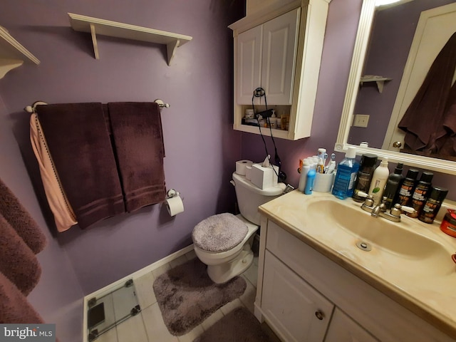 bathroom featuring vanity, toilet, and tile patterned flooring