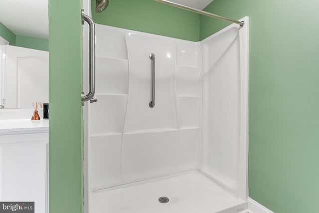full bath featuring vanity and a shower stall