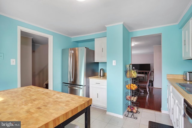 kitchen with crown molding, white cabinets, and stainless steel appliances