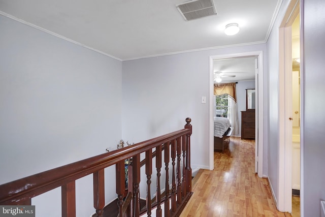 hall featuring crown molding and light hardwood / wood-style flooring