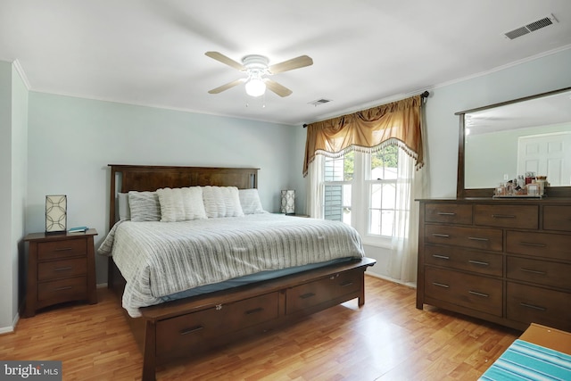 bedroom featuring ceiling fan, light hardwood / wood-style flooring, and crown molding