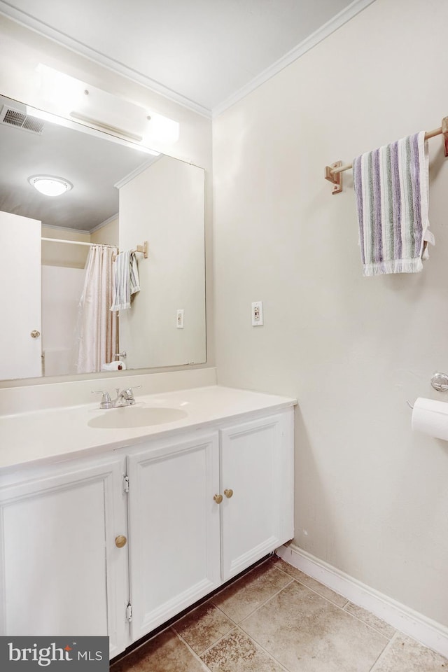 bathroom featuring tile patterned flooring, vanity, walk in shower, and crown molding