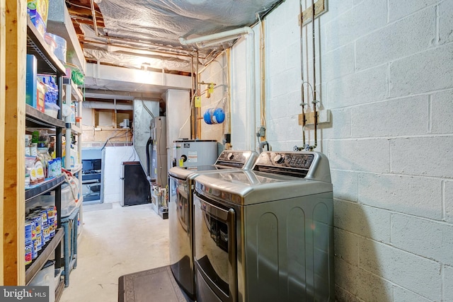 interior space featuring electric water heater and separate washer and dryer