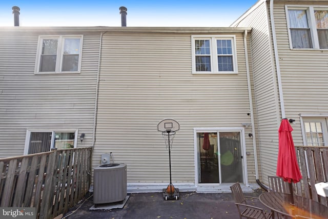 rear view of property with a patio and central air condition unit