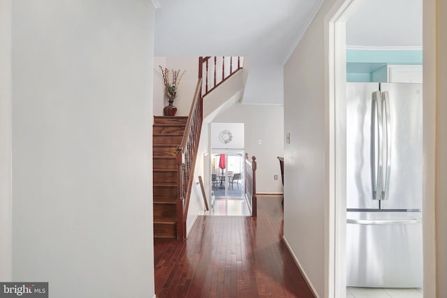 hallway with hardwood / wood-style floors and ornamental molding