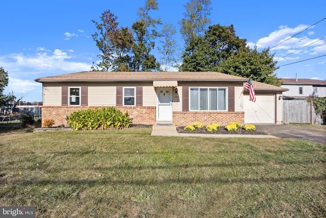 view of front of property featuring a front yard and a garage