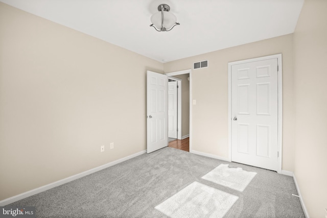 unfurnished bedroom with light colored carpet