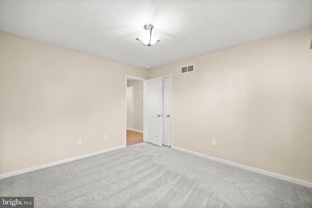 unfurnished room with light carpet