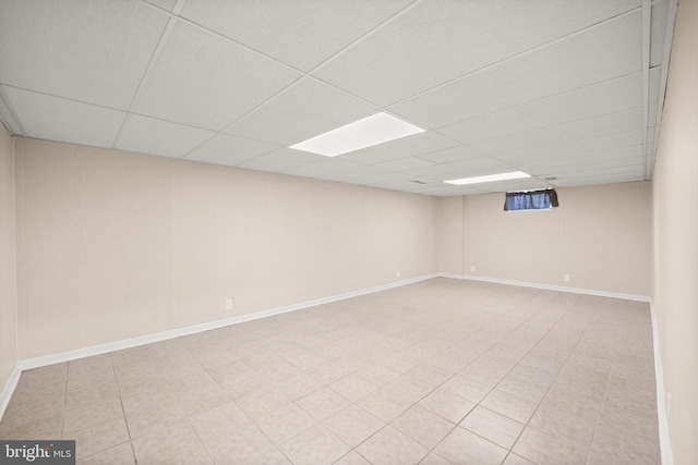 basement with a paneled ceiling