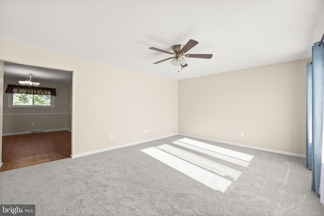 empty room with ceiling fan and carpet floors