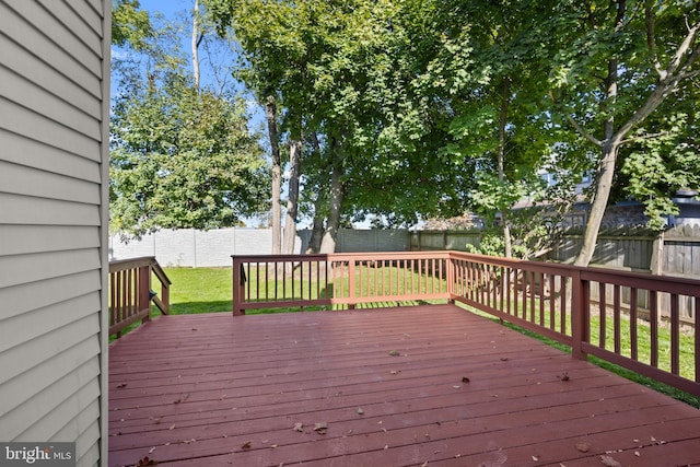 wooden terrace featuring a yard