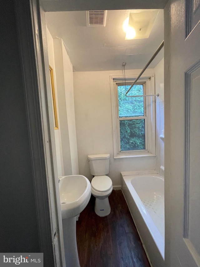 bathroom with toilet, bathtub / shower combination, and wood-type flooring