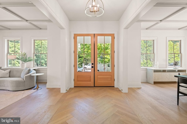 entryway featuring french doors, an inviting chandelier, and plenty of natural light