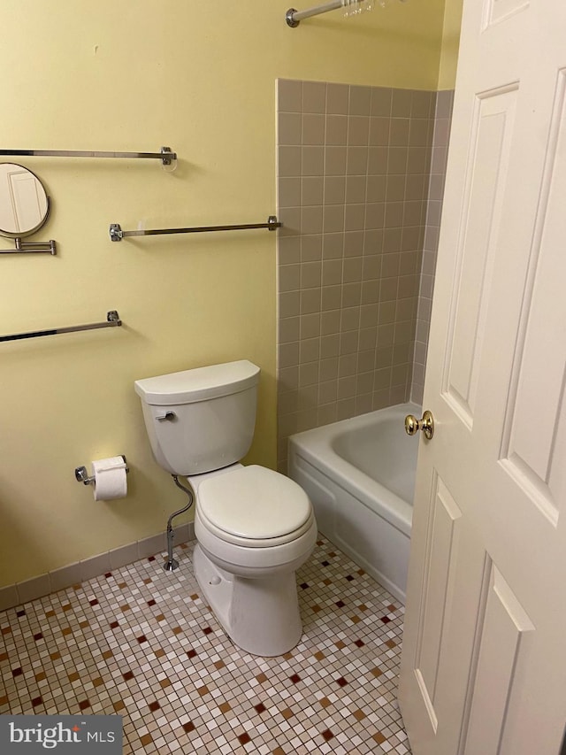 bathroom featuring toilet and tile patterned flooring