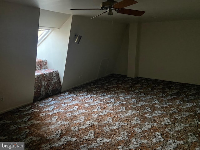 empty room with ceiling fan and carpet flooring