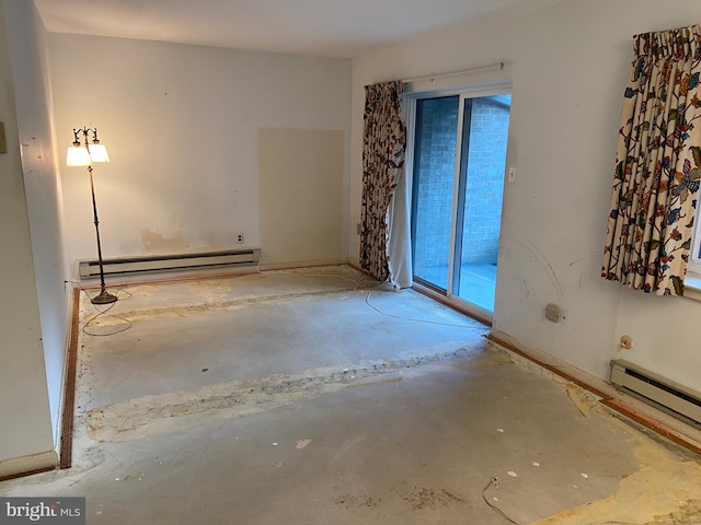 empty room with concrete floors and a baseboard radiator