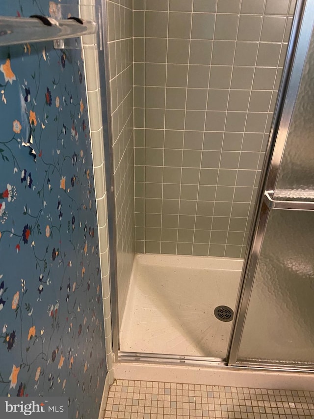 bathroom with a shower with shower door