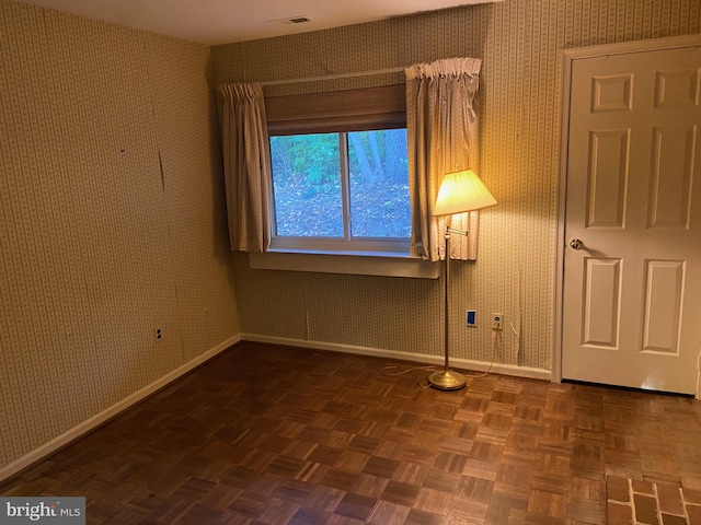 unfurnished room with parquet flooring