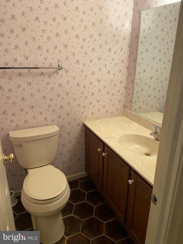 bathroom with vanity, toilet, and tile patterned floors