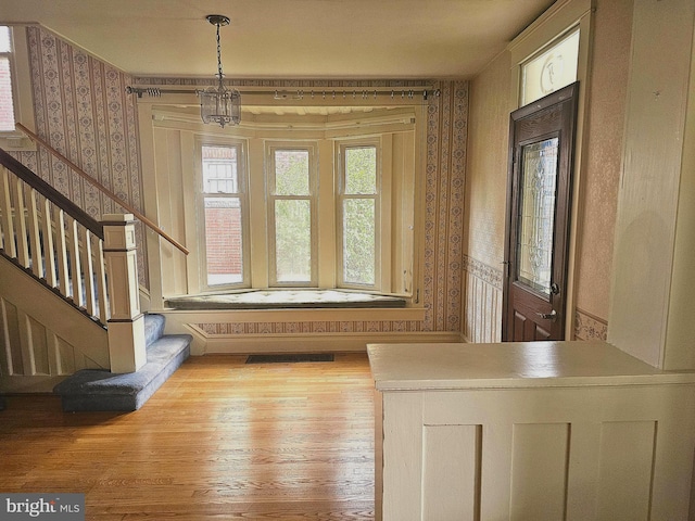 interior space featuring hardwood / wood-style flooring and a chandelier