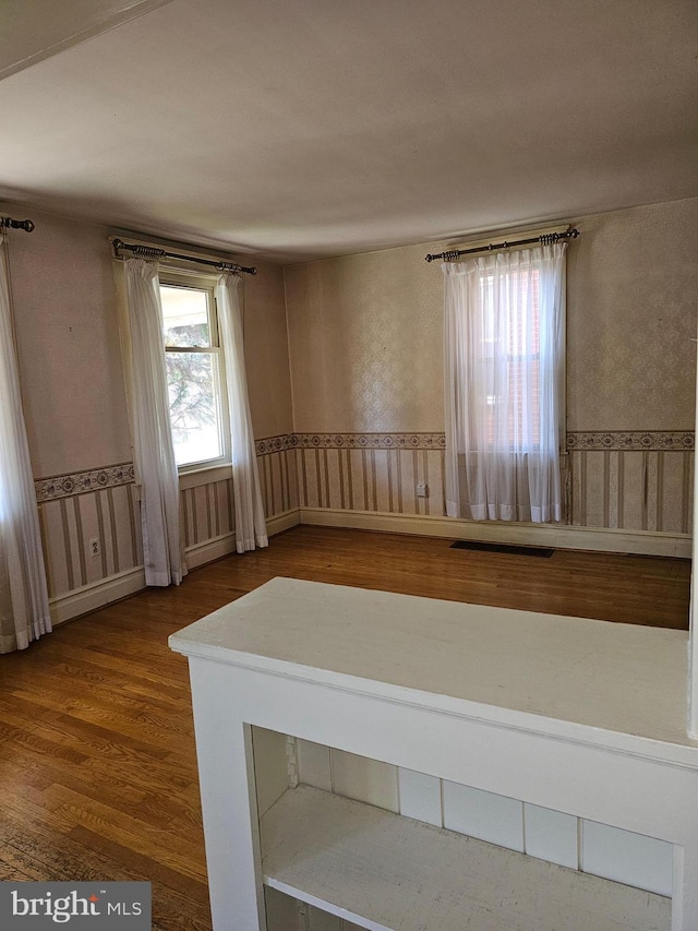 unfurnished room with hardwood / wood-style floors