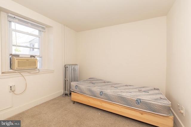 carpeted bedroom with cooling unit and radiator heating unit