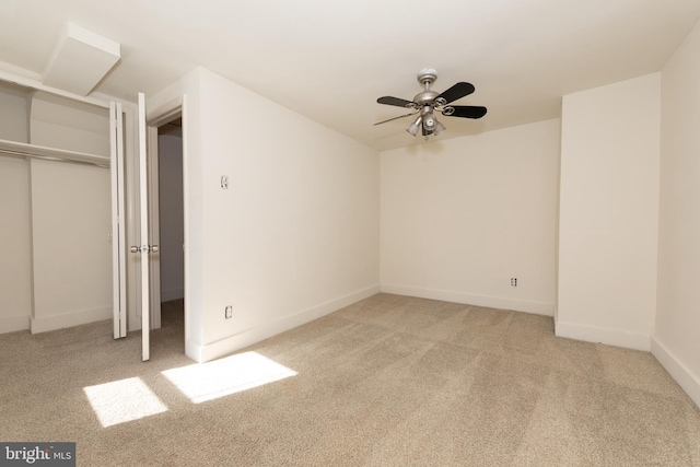 unfurnished bedroom featuring light carpet, a closet, and ceiling fan