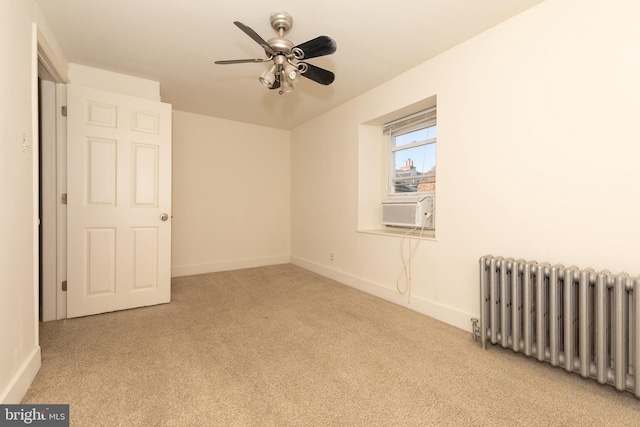 carpeted empty room with ceiling fan, cooling unit, and radiator heating unit