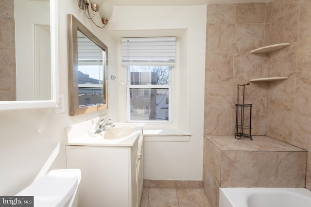 bathroom with vanity, tile patterned flooring, and a washtub