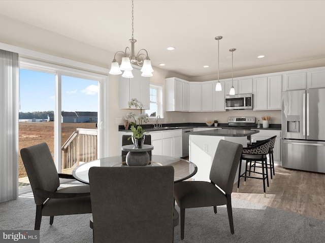 dining space featuring hardwood / wood-style flooring and an inviting chandelier