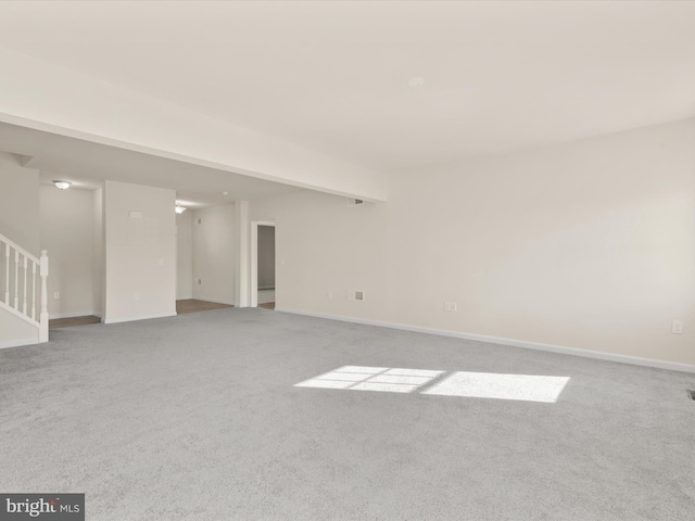 unfurnished room featuring light colored carpet