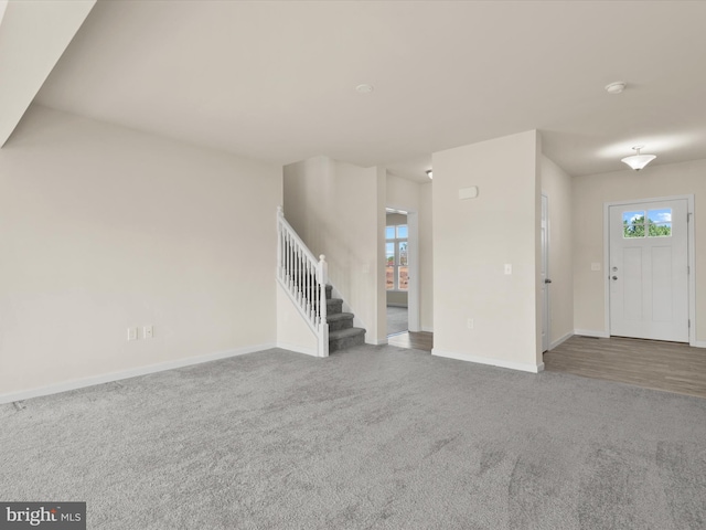 unfurnished living room with carpet