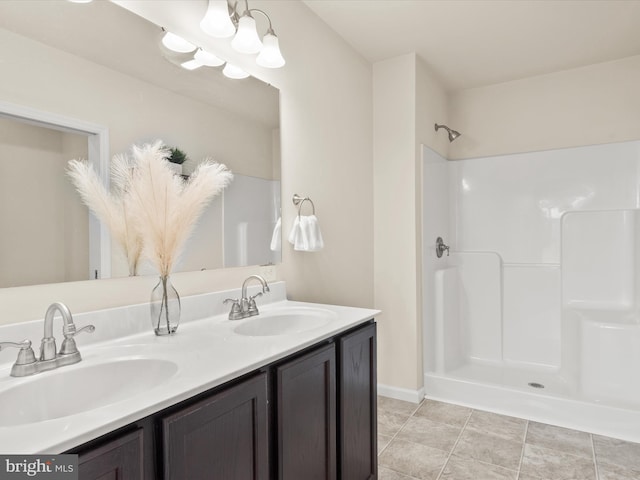 bathroom with vanity, a shower, and tile patterned floors