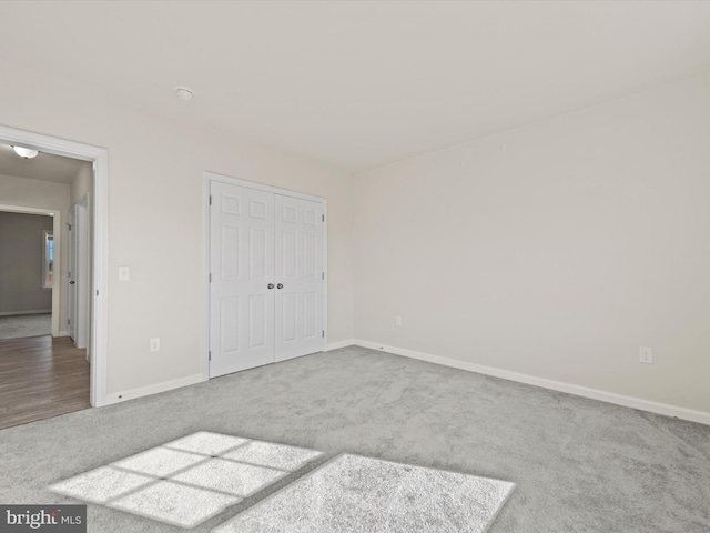 unfurnished bedroom featuring a closet and carpet flooring