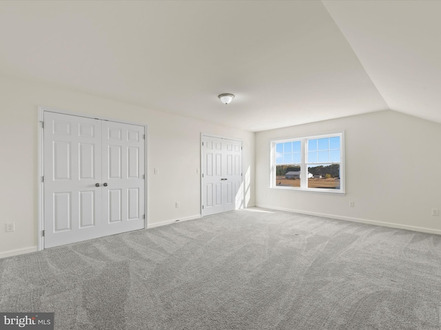 interior space with carpet and lofted ceiling