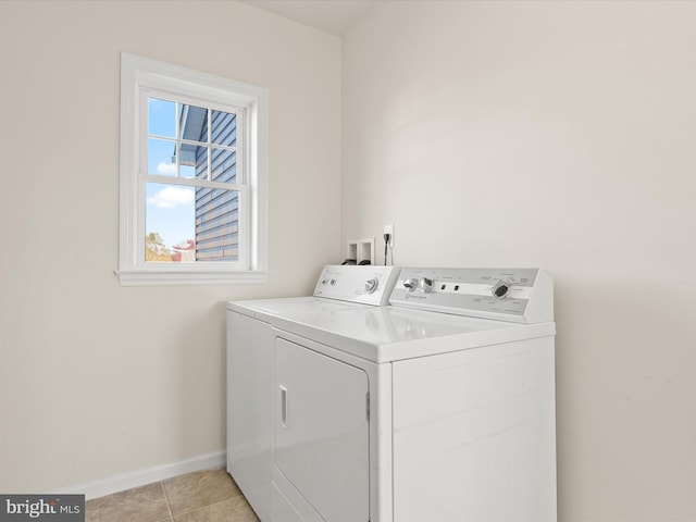 washroom with light tile patterned floors and washing machine and clothes dryer