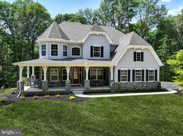 view of front of house with a porch and a front lawn