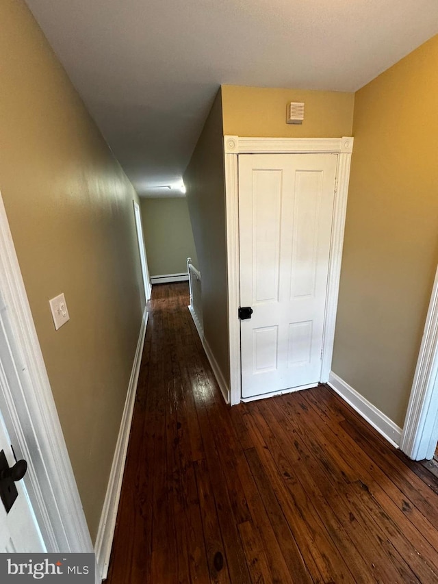 hallway with dark hardwood / wood-style floors